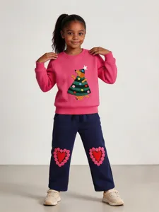 Girls pink crewneck sweatshirt and blue sweatpants set with cute Christmas tree and heart appliques.