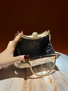 Exquisite pearl embroidered evening clutch detail showing open structure and rhinestone clasp.