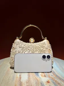 Elegant beaded evening clutch bag with gold handle and pearl clasp for women detail view.