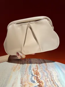 Elegant beige ruched clutch bag detail shot, showcasing soft leather texture and chic folds.