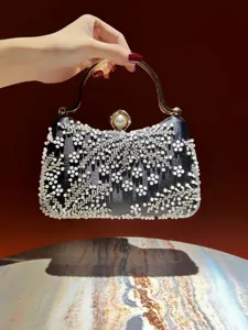 Elegant black beaded evening clutch with gold handle and pearl clasp for women parties.