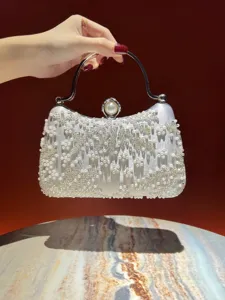 Pearl beaded evening clutch bag detail showing exquisite craftsmanship and metallic handle design.