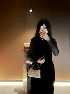 Elegant beaded evening handbag with metal top handle and chain strap for women party wear.