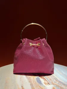 Exquisite burgundy glitter bucket bag detail with a luxury gold round handle and chain.