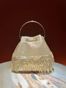 Gold glitter evening bag detail, chic bucket handbag with metal ring handle and fringe.