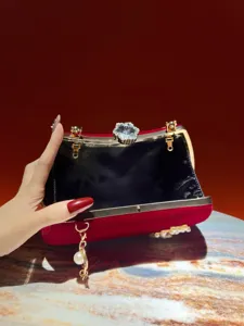 Borsa da sera a pochette in velluto rosso con chiusura floreale strass e nappa perla.