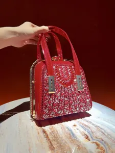 Stunning red evening bag detail with sparkling rhinestones and pearls for luxury events.