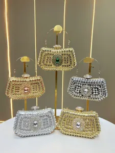 Elegant rhinestone evening clutch bag with metal handle and shimmering crystal decorations for women banquets.