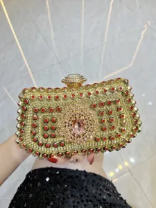 Exquisite rhinestone evening clutch bag with golden metallic frame and sparkling crystals.