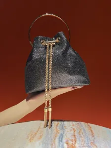 Exquisite sparkling evening bucket bag detail, featuring shiny glitter fabric and gold chain.