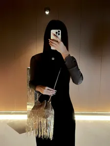 Detailed view of the elegant metallic fringe bucket evening bag showcasing fine tassel details.