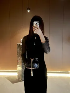 Black glittering bucket bag for women, elegant evening handbag with chain strap, chic.