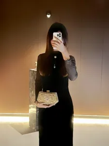 Elegant crystal rhinestone evening clutch bag detail, shining gold party purse accessory.