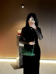 Elegant green pleated evening clutch bag with gold chain strap for women party dress outfit.
