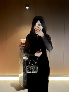 Elegant beaded evening bag with metal handle and chain strap, perfect for parties and events.