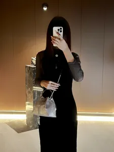 Shimmering silver evening bucket bag featuring a chain strap, elegant style detail view.