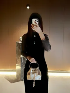 Detail view of glittering bucket bag featuring metal ring handle in chic interior.