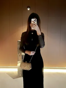 Detail view of the luxury rhinestone evening clutch bag sparkling under warm indoor lighting.