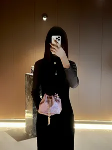 Elegant sparkly pink bucket handbag with chain strap for women evening party styling.