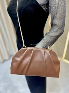 Brown pleated clutch bag with gold chain strap, stylish women's crossbody bag detail.