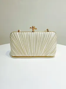 Elegant pleated satin clutch bag with gold hardware and pearl accents for evening party.