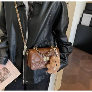 Brown quilted chain shoulder bag for women, stylish crossbody bag with cute bear charm.