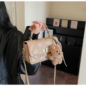Chic quilted chain shoulder bag for women, stylish crossbody handbag with cute bear charm.