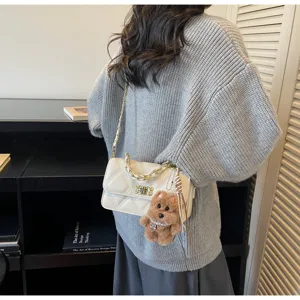 Chic quilted chain shoulder bag for women, stylish crossbody handbag with cute plush puppy charm.