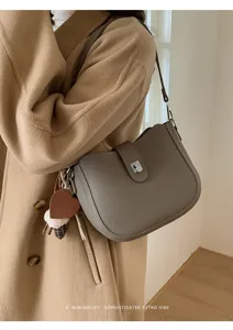 Korean minimalist retro shoulder bag with chic saddle design and elegant leather finish detail.