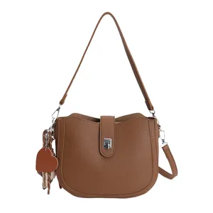 Brown PU leather shoulder bag for women, stylish minimalist crossbody bag with heart charm.