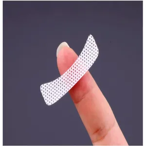 Non-woven eyelash extension isolation eye patch detail view, breathable mesh cosmetic tool.