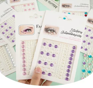 Detailed shot of 3D pearl rhinestone face stickers and nail art gems with self-adhesive backing.