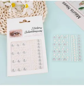 Detailed shot of pearl and rhinestone face and nail stickers sheet with elegant designs.