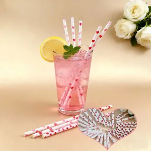 Valentine pink paper drinking straws detail shot with romantic hearts pattern decor
