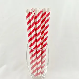 Close-up detail of red and white striped paper straws in glass, eco-friendly tableware.