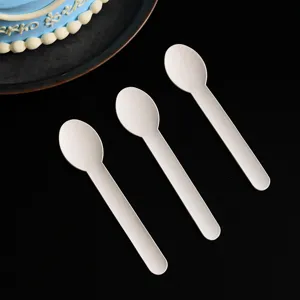 Close up view of white disposable biodegradable paper spoons tableware set details