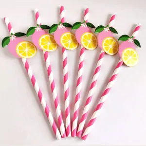 Detailed view of pink and white striped paper straws with cute lemon decorations for parties.