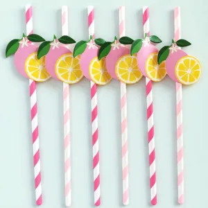 Detail view of pink and white striped paper straws with cute lemon fruit cutouts.