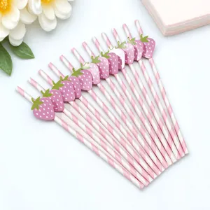 Detailed view of pink striped paper straws featuring cute strawberry party decorations.