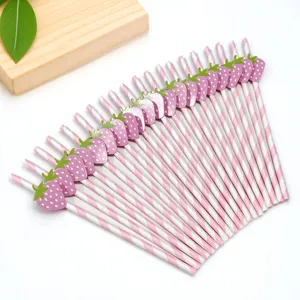 Close-up of pink striped paper straws featuring cute strawberry decorations for party details.