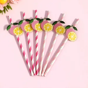 Closeup of disposable paper straws with cute pink lemon decor, perfect for party drinks.