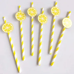 Close-up detail of yellow and white striped paper straws featuring cute lemon slice cutouts.