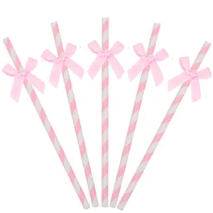 Ensemble de pailles en papier à nœud rose, design rayé pour fête d'anniversaire, déco de table.