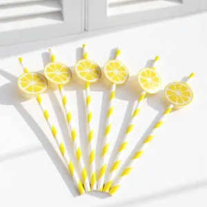 Decorative yellow striped paper drinking straws with cute lemon slice cards for party use.