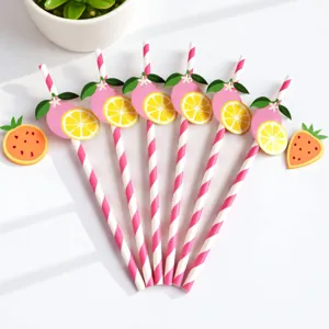 Close-up detail of creative fruit-themed striped paper straws with lemon decors.