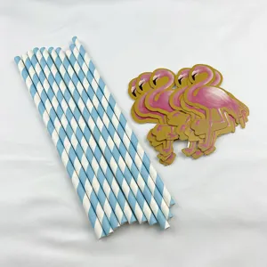 Close-up detail view of blue white striped paper straws and pink flamingo party decorations.