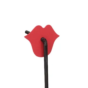 Creative red lips party straw detail shot, fun disposable plastic drinking straw for events.