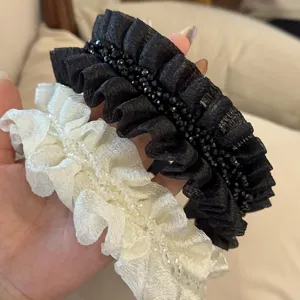 Close-up detail of sweet wrinkled hairband with crystal beads for cute daily styling.
