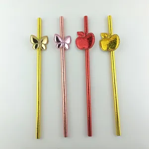 Decorative paper straws with shiny butterfly and apple charms for party drinks and cake decor.