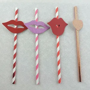 Close-up detail of creative party paper straws with fun red lips and heart decor accents.